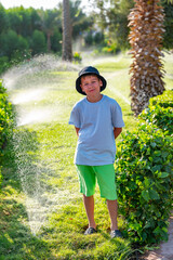 A boy on the beach in a 
 panama hat
