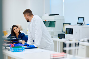 Fototapeta premium Laboratory team collaborates on scientific research in a modern facility during the daytime