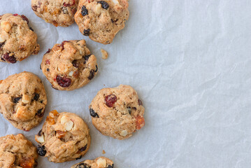 freshly baked fruitcake cookies on baking paper background.