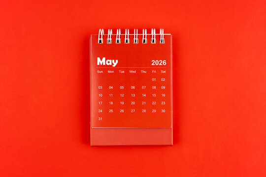 May 2026 red color desk calendar on red  background.