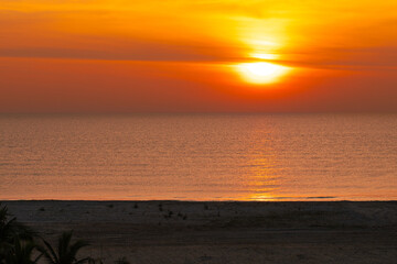 Beautiful sunrise over Hua Hin beach in Prachuap Khiri Khan, Thailand, featuring golden sunlight, calm sea, and a peaceful coastal atmosphere, ideal for travel, tourism, and nature photography.