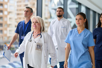 Healthcare professionals walking together in a modern hospital corridor during a busy shift in the afternoon