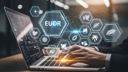 Person working on a laptop with EUDR graphics and icons related to environmental sustainability and digital technology displayed on the screen and surrounding area.