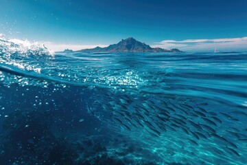 Fototapeta premium Split shot showcasing a turquoise ocean's depths, a distant island, and sky