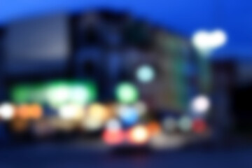 A blurred or bokeh effect of a populated area with people and cars.