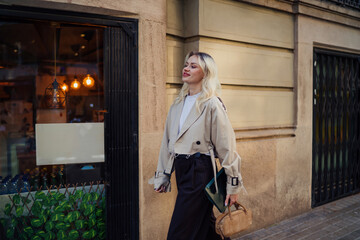 Confident young woman walking down city street with tablet and handbag. Scene highlights freedom, modern mobility, and the tech-enabled ease of urban freelance work