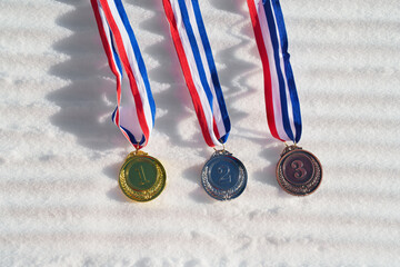 golden medal on the textured ski slopes in the snow - winter sport successful concept. Skiing,...