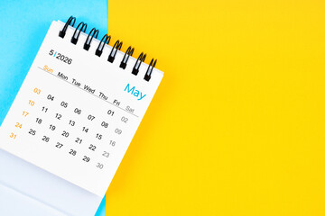 May 2026, Monthly desk calendar for 2026 year on yellow and blue background.