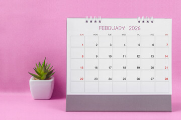 February 2026 desk calendar for year 2026 on pink background.