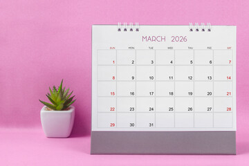 March 2026 desk calendar for year 2026 on pink background.
