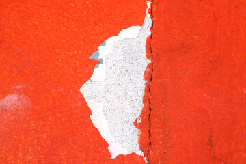 Close-Up of Peeling Red Paint with a Exposed Underlayer Texture