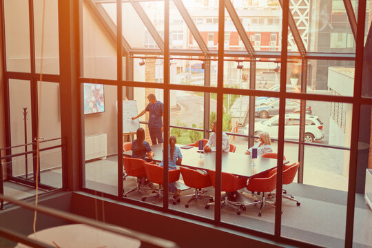 Team collaborates in a modern conference room during a productive business meeting in an urban setting - Powered by Adobe