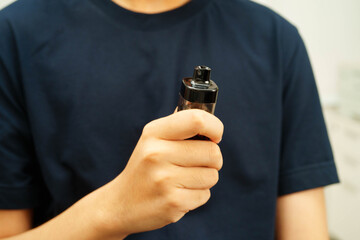 Man holding electronic cigarettes, no smoking.