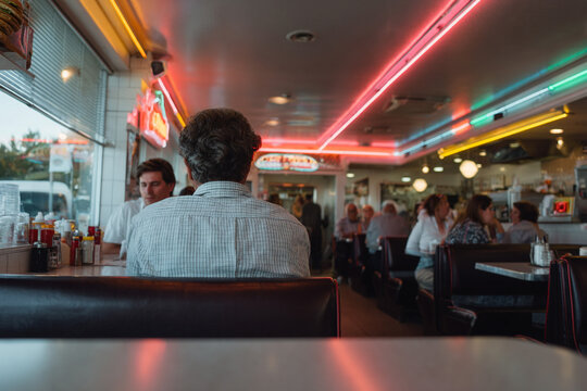 Old-fashioned diner interior with retro neon.