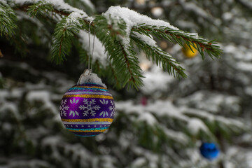Christmas tree decoration on a snowy spruce branch
