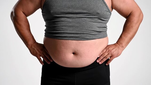 Overweight woman showing body fat and belly bloat before and after weight loss, diet, or fitness program footage