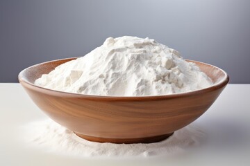 White flour filling a wooden bowl, ready for cooking and baking