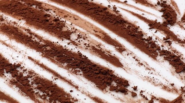 Organic dark cocoa powder rotating on white background for advertising