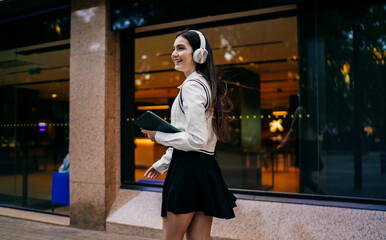 Woman sitting in restaurant interacting with tablet using stylus and credit card, focused on digital transaction process, concept of smart payment and secure mobile technology usage.