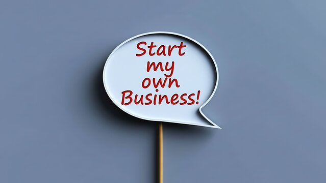 Speech bubble sign on a stick with red text saying 'Start my own Business!' against a plain gray background, representing entrepreneurial aspirations and new ventures.