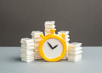 Stacks of papers and a stopwatch. Paperwork and bureaucratic burden on businesses. Reporting...