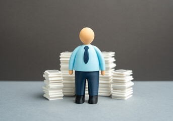 An office worker and stacks of papers and documents. Paperwork and reporting. Bureaucracy and the burden on staff reducing efficiency, motivation and time for productive and creative work tasks