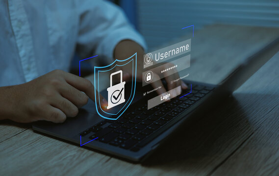User accessing secure login system on laptop with digital shield and password interface. Concept of cybersecurity, data privacy, authentication online security, protected information technology