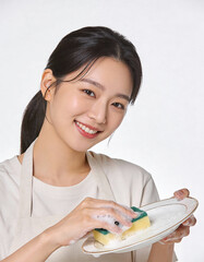 Young woman washing her face with sponge, closeup portrait on white background