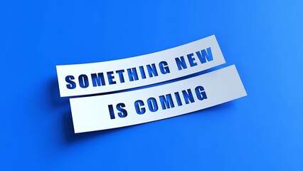 Bold white paper banners with cut-out blue text "SOMETHING NEW IS COMING" on a vibrant solid blue background, creating a sense of anticipation and announcement.