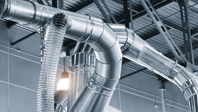 Air ducts in a factory for removing sawdust and dust during the production of furniture or other products, viewed from the bottom up.