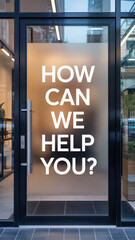 Modern office glass door with white "HOW CAN WE HELP YOU?" text decal on storefront entrance