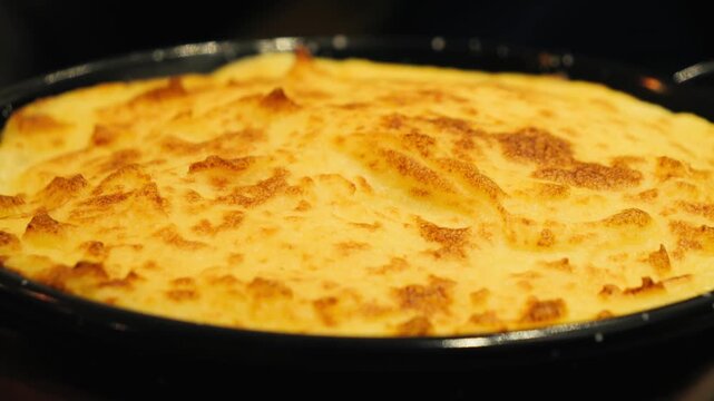 Duck Parmentier or Parmentier de Canard is a classic, hearty casserole from France, using shredded duck confit under a creamy mashed potato topping. High quality 4k footage