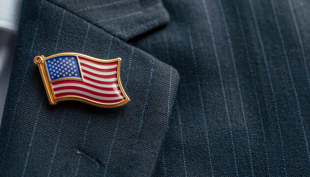 Close up detail of USA United States national flag enamel lapel pin badge on dark grey business suit jacket for politics concepts