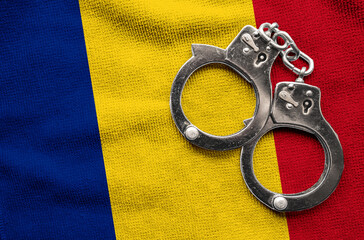 Flag of  Romania and police handcuffs. Crime and offenses in country Concept
