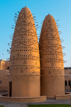 Doha, Qatar - 05 November 2025: View of the majestic Katara Cultural Village's pigeon towers, their earthen hues contrasting with the clear blue sky above.