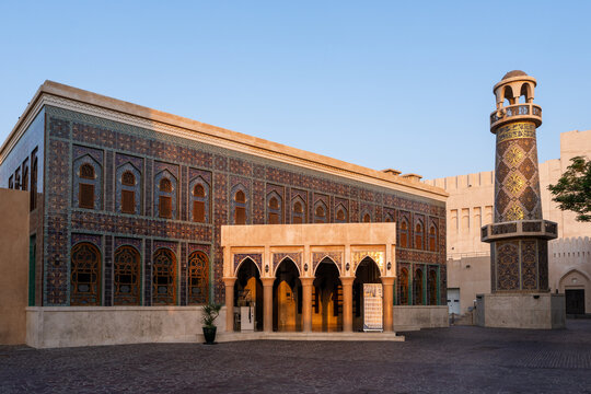 Doha, Qatar - 05 November 2025: View of the Amiri Diwan building with its intricate geometric patterns and a cylindrical minaret, all bathed in the soft glow of early morning.