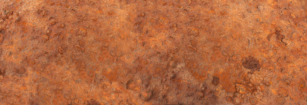 Rusty metal surface showing textured orange corrosion