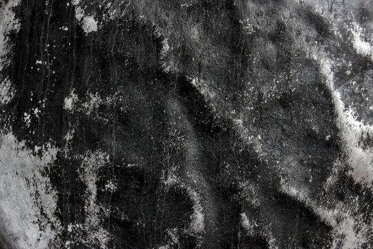A black and white abstract macro texture of burnt stoneware. Adhering carbon soot creates a dramatic pattern on the grooved metal surface. - Powered by Adobe