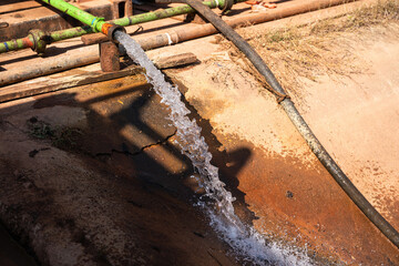 Contaminated sewage dirty fluid mix with chemical or crude oil is draining into public water place. Environmental issue from industrial.