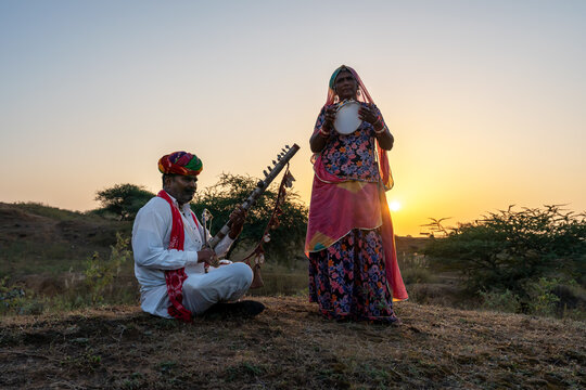 Rajasthani folklore musician and singer with ravanahatha and the Khanjari Dafli instrument in Pushkar Rajasthan India