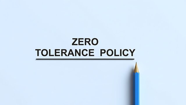 Zero Tolerance Policy text written in bold black font with a simple line underneath, next to a sharp blue pencil on a light blue paper background