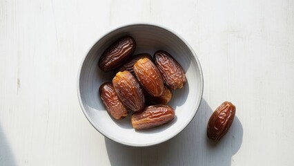 Bowl of Sweet Medjool Dates with Sunlight on White Table