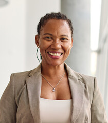 Portrait of a smart young businesswoman using a smartphone phone and texting in the office. Startup and succesful business concept