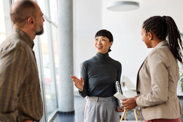 Group of young businesspeople having a meeting or presentation and seminar standing in the office. Portrait of a young businesswoman talking