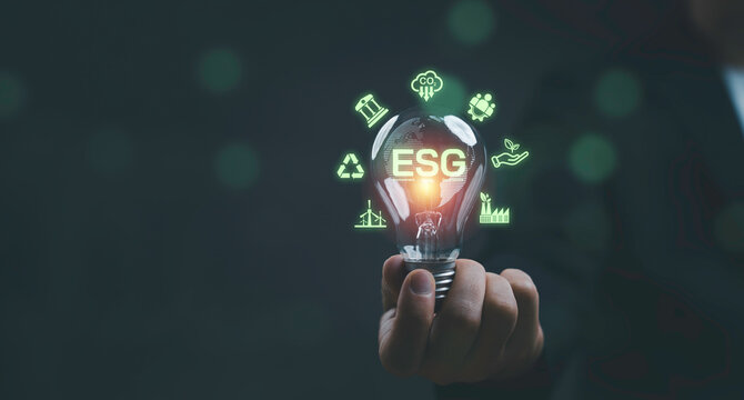 ESG sustainability concept with glowing light bulb and environmental icons for environmental social governance by green responsible investment, carbon reduction and sustainable business strategy. - Powered by Adobe
