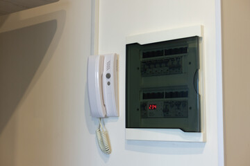 Intercom with electrical panel in the apartment on a white wall close-up