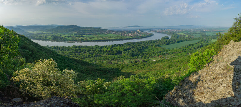 View of the Danube river flowing through lush green valleys, creating a serene landscape under a vast sky, Sturovo, Nitra Region, Slovakia.