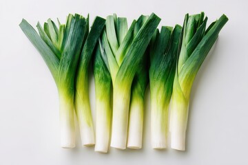 Minimalist presentation of fresh leeks for culinary imagery, long green stalks and white bases