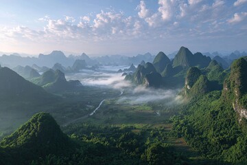 Aerial view of lush, green, karst mountains and valleys with fog and blue skies