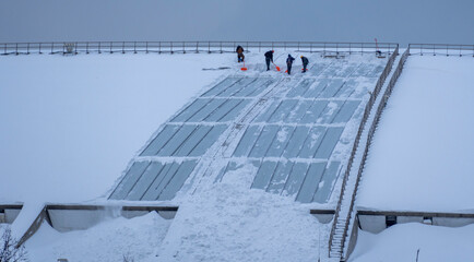 Snow Removal Effort on a Roof During Winter Conditions